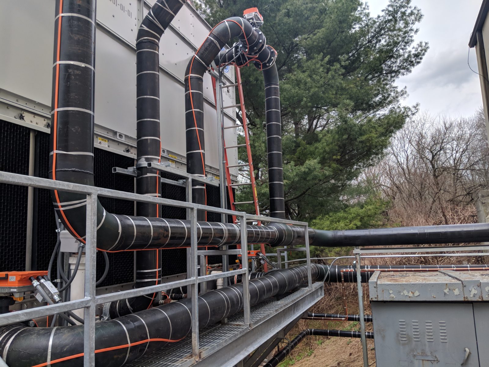 Insulated process piping and rolling offsets running to a cooling tower